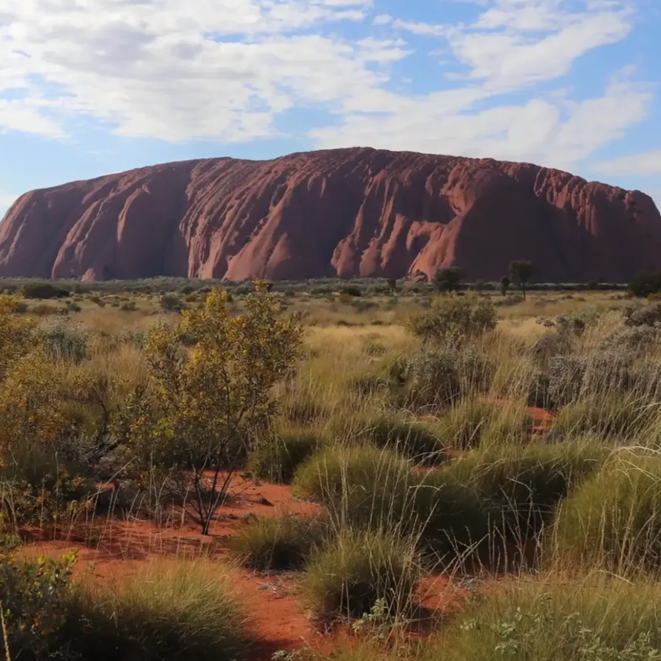 uluru rock formation under clear sky